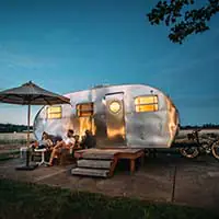 couple in front of caravan at night